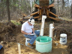 A geoenvironmental team member performing infiltration testing.
